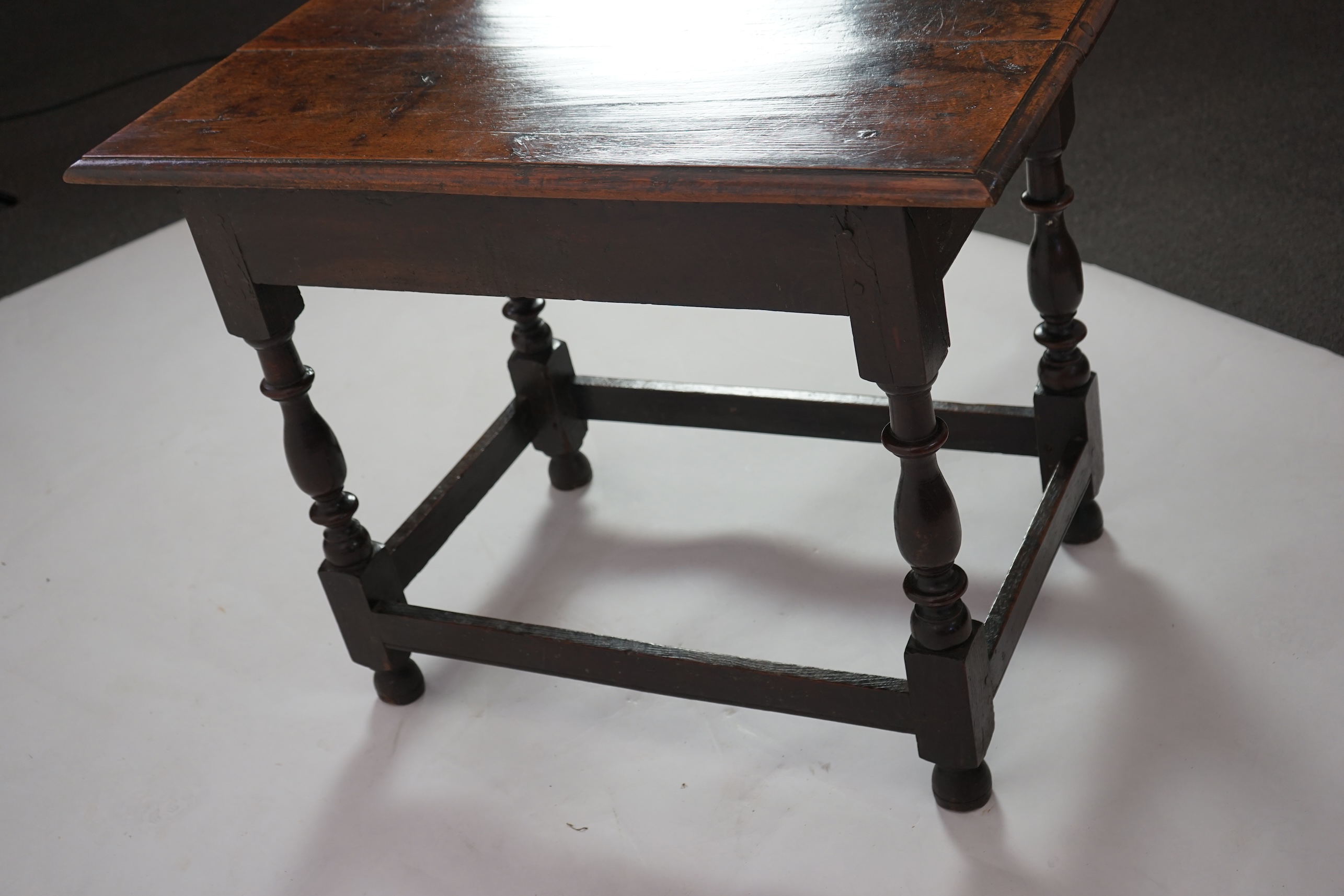 An early 18th century and later oak side table